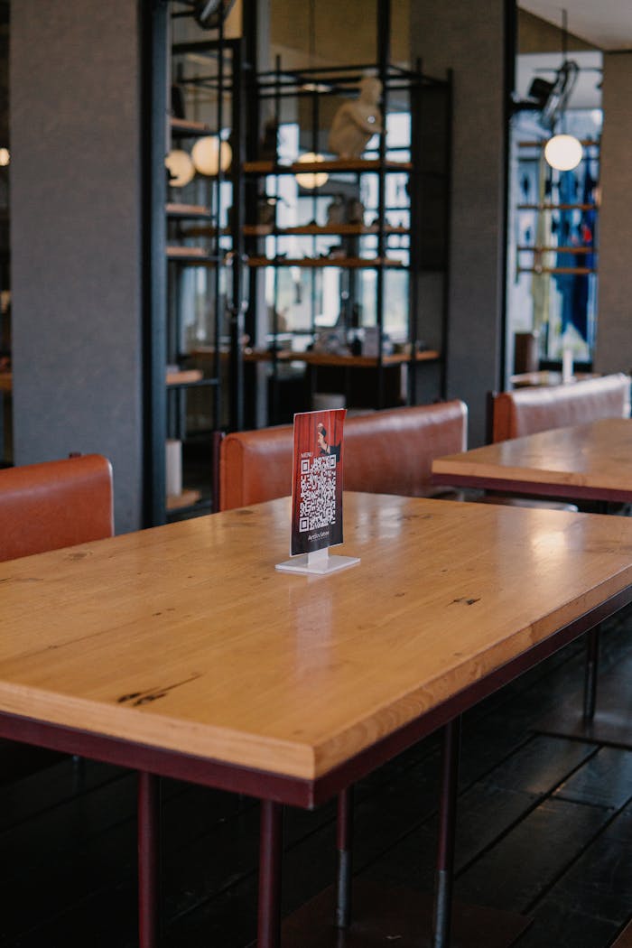 Warm and inviting cafe interior with wooden tables and leather seating, offering a relaxing atmosphere.